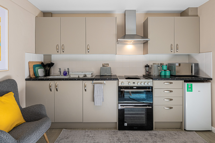 a bedroom with a bed and desk in a room