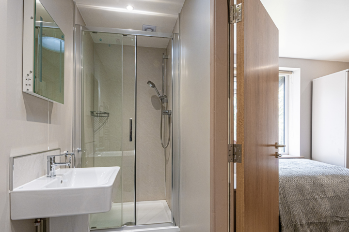 a hotel room with a sink and a mirror