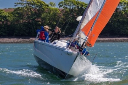 a group of people riding on the back of a boat in the water