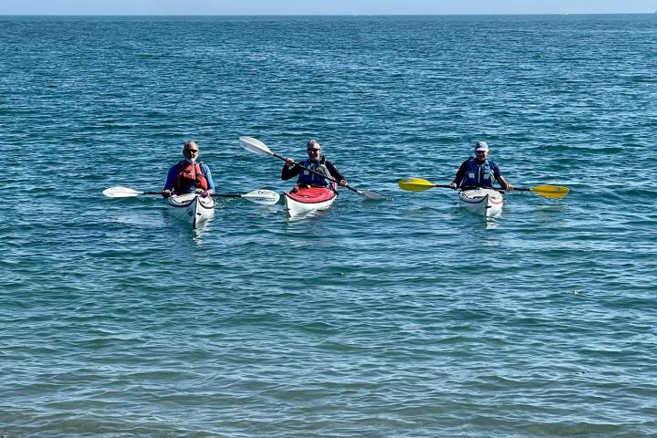 a group of people riding skis on a body of water