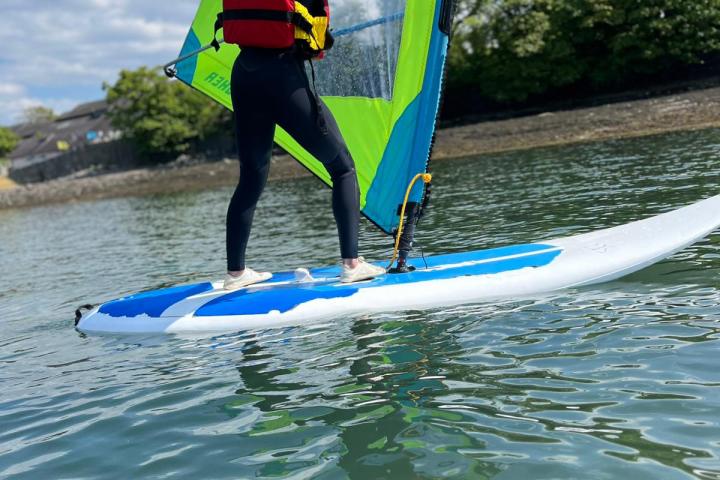 a girl riding a wave on a surf board on a body of water