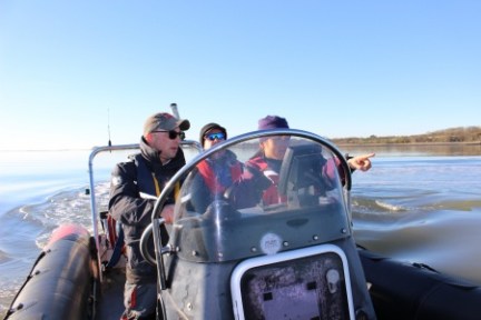 a man driving a boat in the water