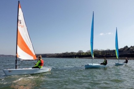 a man riding on the back of a boat in a body of water