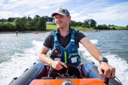 a man sitting in a boat on a body of water