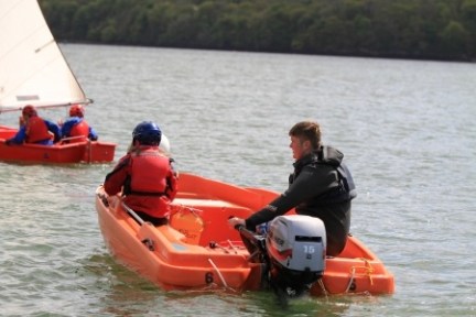 a group of people in a small boat in a body of water