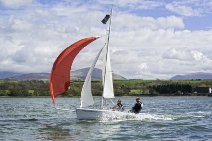 a man flying a kite in a large body of water