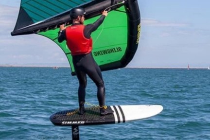 a person riding a surf board on a body of water