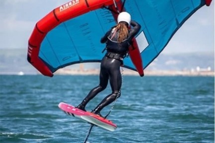 a person riding a surf board on a body of water