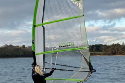 a person in a green boat on a body of water