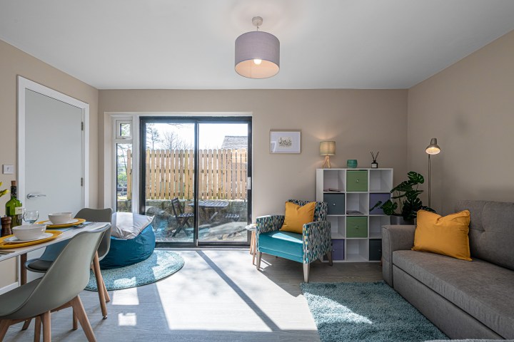 a living room filled with furniture and a large window