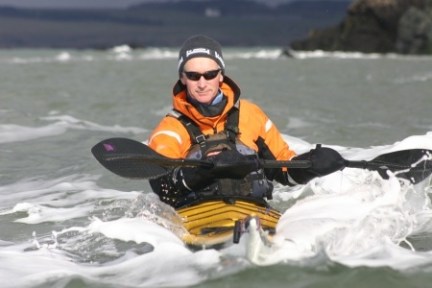 a man riding a snow board on a body of water