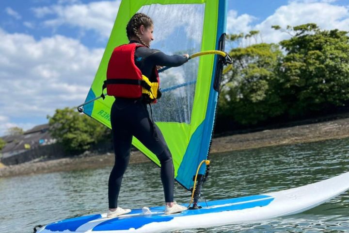 a person riding a surf board on a body of water