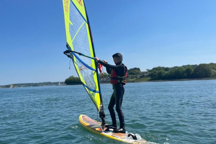 a person riding a surf board on a body of water