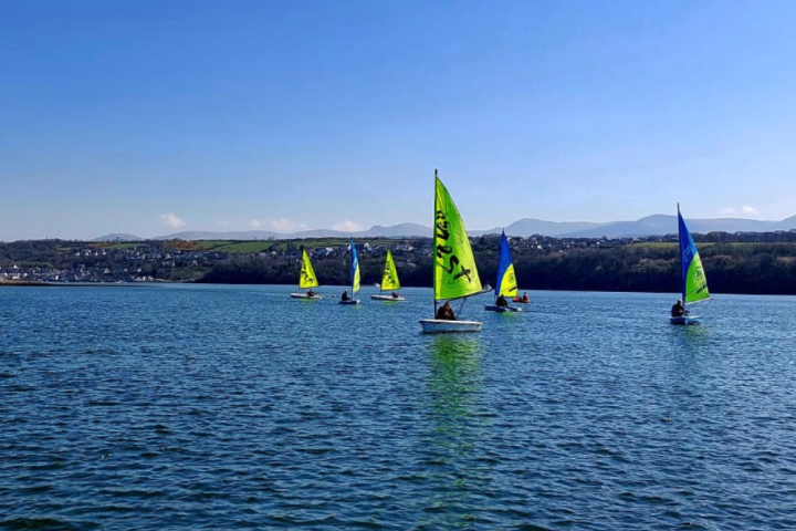 a green boat on a body of water