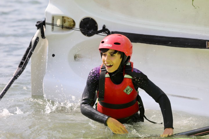 a person riding on the back of a boat in the water