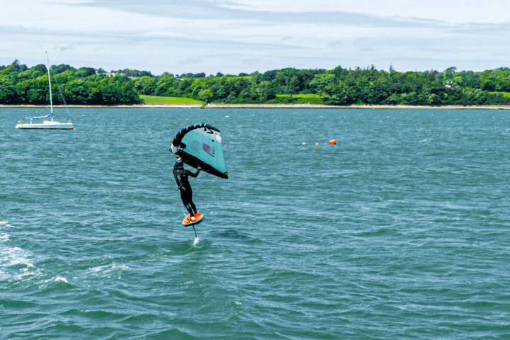 a group of people riding skis on a body of water