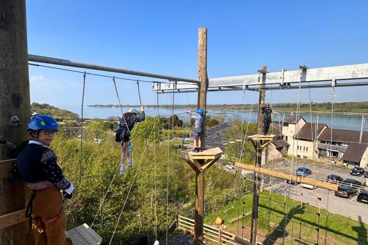 a group of people on a train track near a fence