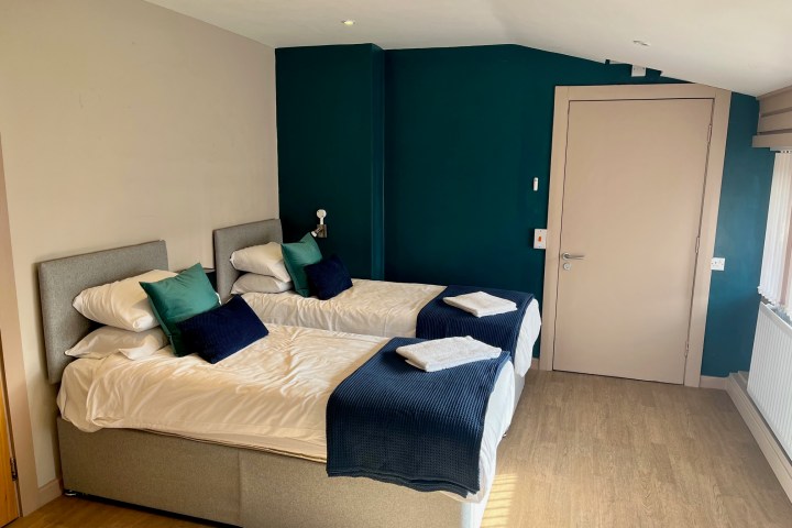 a bedroom with a bed and desk in a room