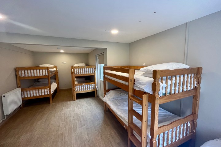 a bedroom with a bed and a chair in a room
