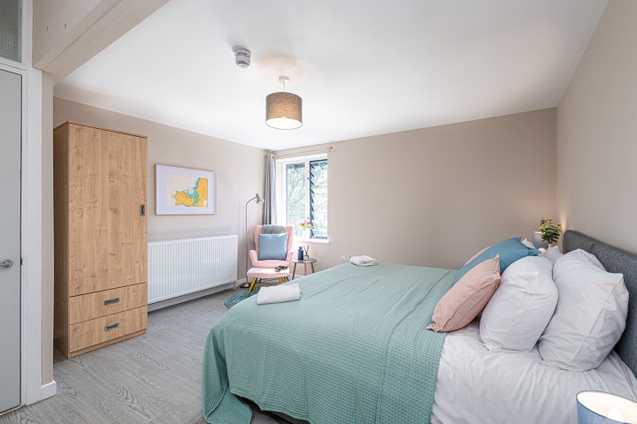 a bedroom with a bed in a room