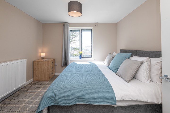 a bedroom with a large bed in a room